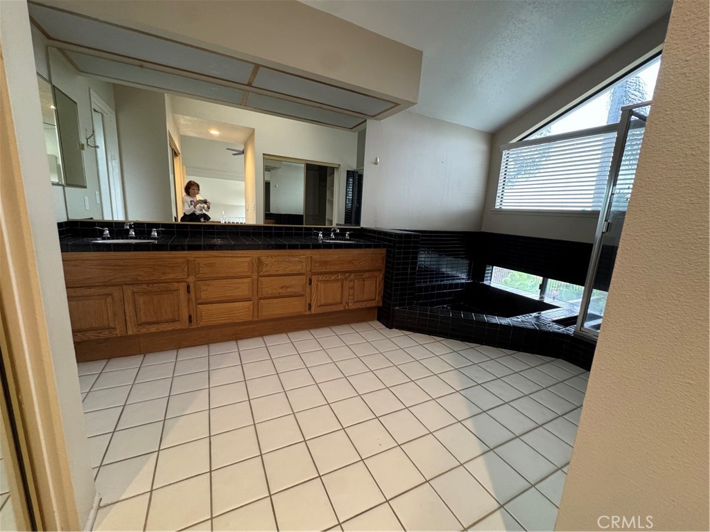 6 Recodo Irvine, CA 92620 - Photo 16 of 33 a bathroom with a sink a mirror and a bathtub