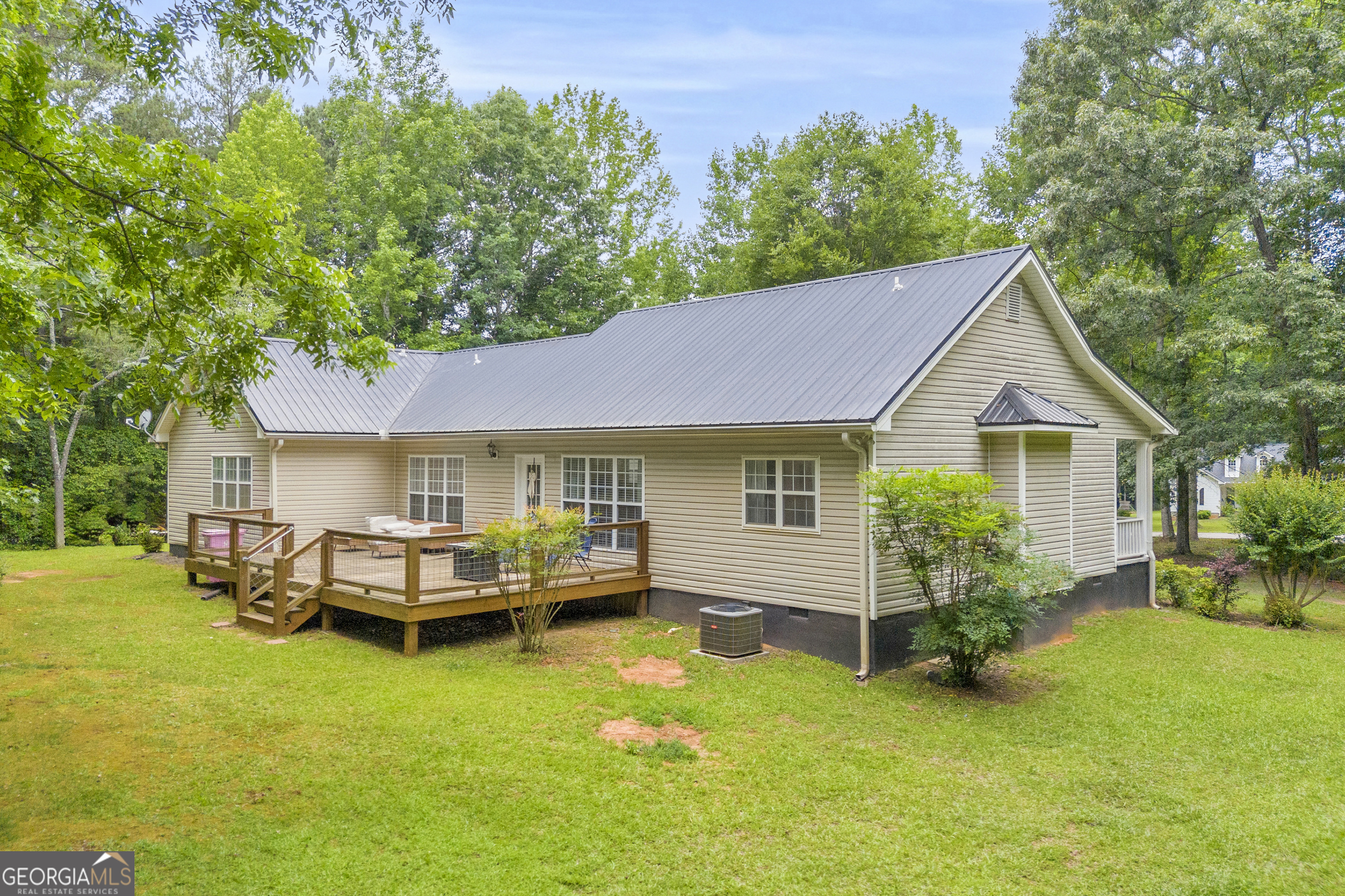 163 Tuxedo Drive Commerce, GA 30530 - Photo 7 of 62 a front view of a house with a garden and deck