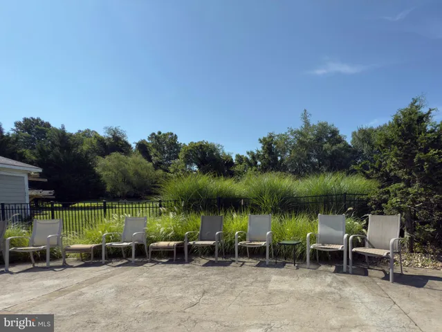 an outdoor sitting area with lake view