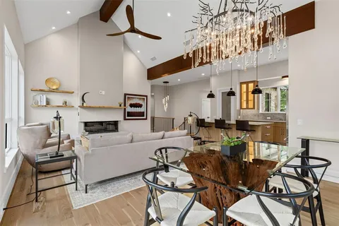 a living room with lots of furniture and a chandelier