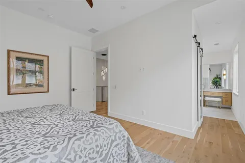 a bedroom with a bed and a view of kitchen
