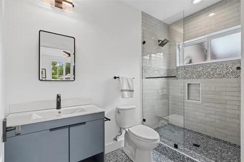 a bathroom with a toilet sink and shower