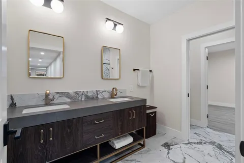 a bathroom with a granite countertop sink mirror and double