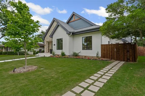 a front view of house with a garden