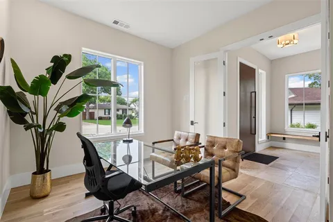a view of a dining room with furniture window and wooden floor
