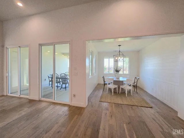 a dining room with furniture and wooden floor