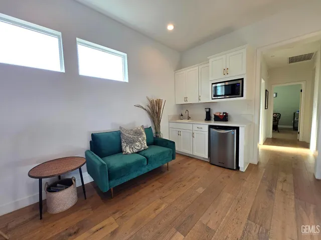 a living room with furniture and a wooden floor