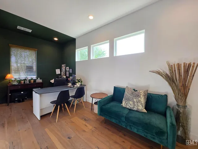 a living room with furniture and wooden floor