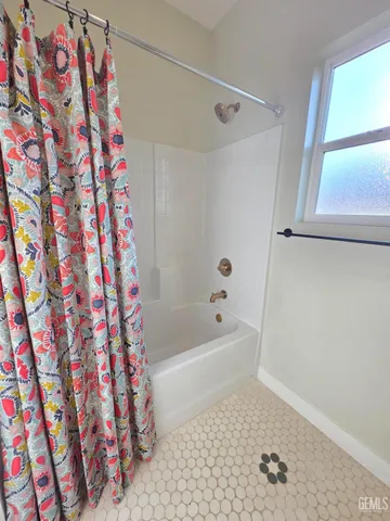 a bathroom with a bathtub and shower