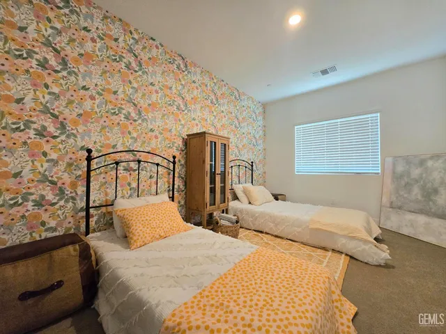 a bedroom with double bed and a window