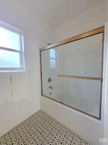 a bathroom with a glass shower door