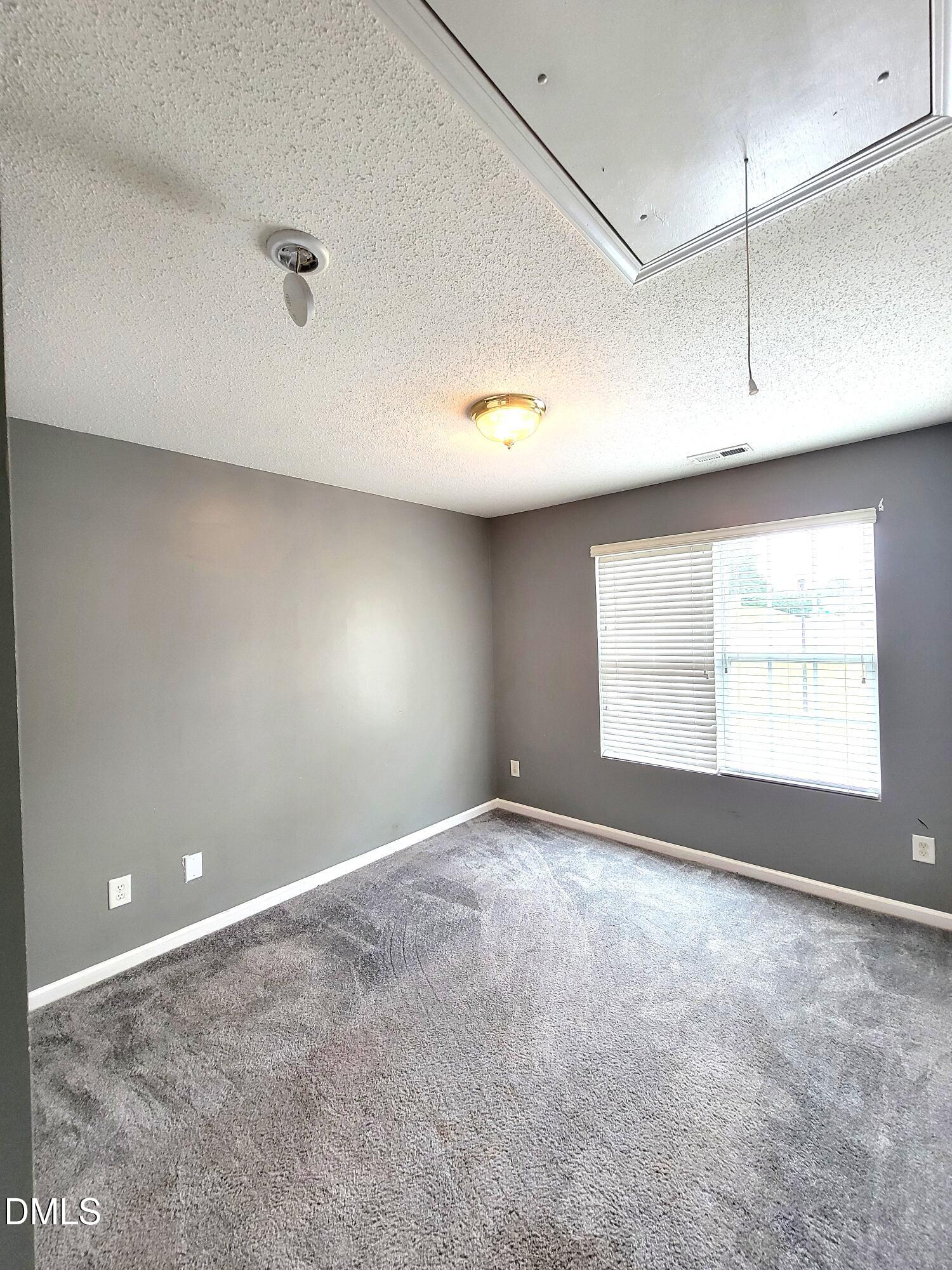 3402 Sosa Road Raleigh, NC 27610 - Photo 9 of 11 a view of an empty room with a window
