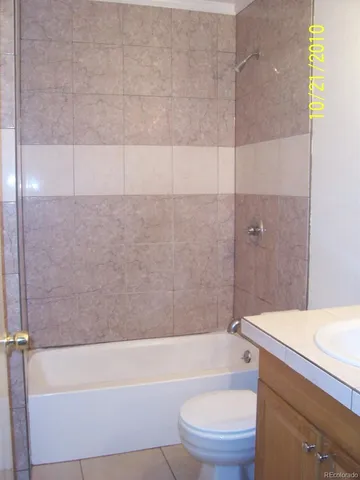 a bathroom with a sink a toilet and bathtub