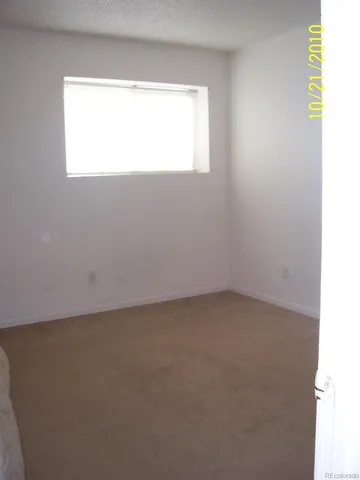 a view of an empty room and a window