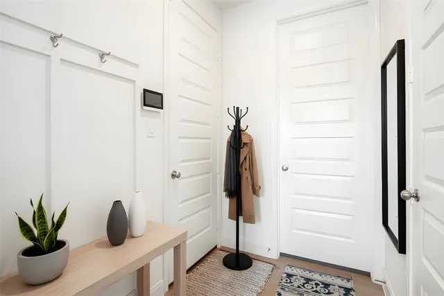 a bedroom with bed and a potted plant