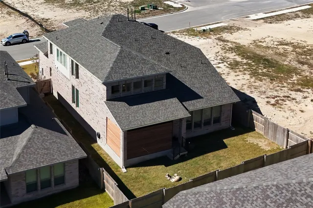 an aerial view of a house with a yard