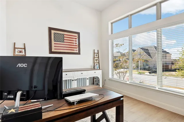 a view of a workspace with furniture and a window