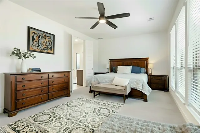 a bedroom with a bed and a dresser