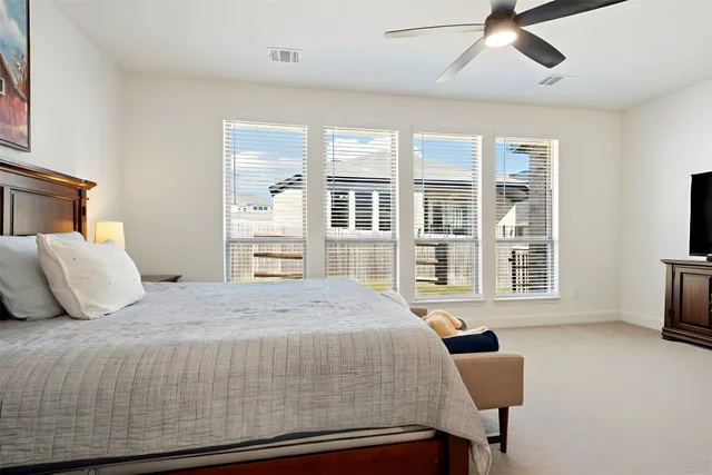 a bedroom with a large bed and a window