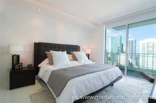 a bedroom with a bed and large mirror