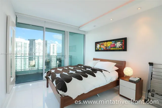 a bedroom with bed and a large window