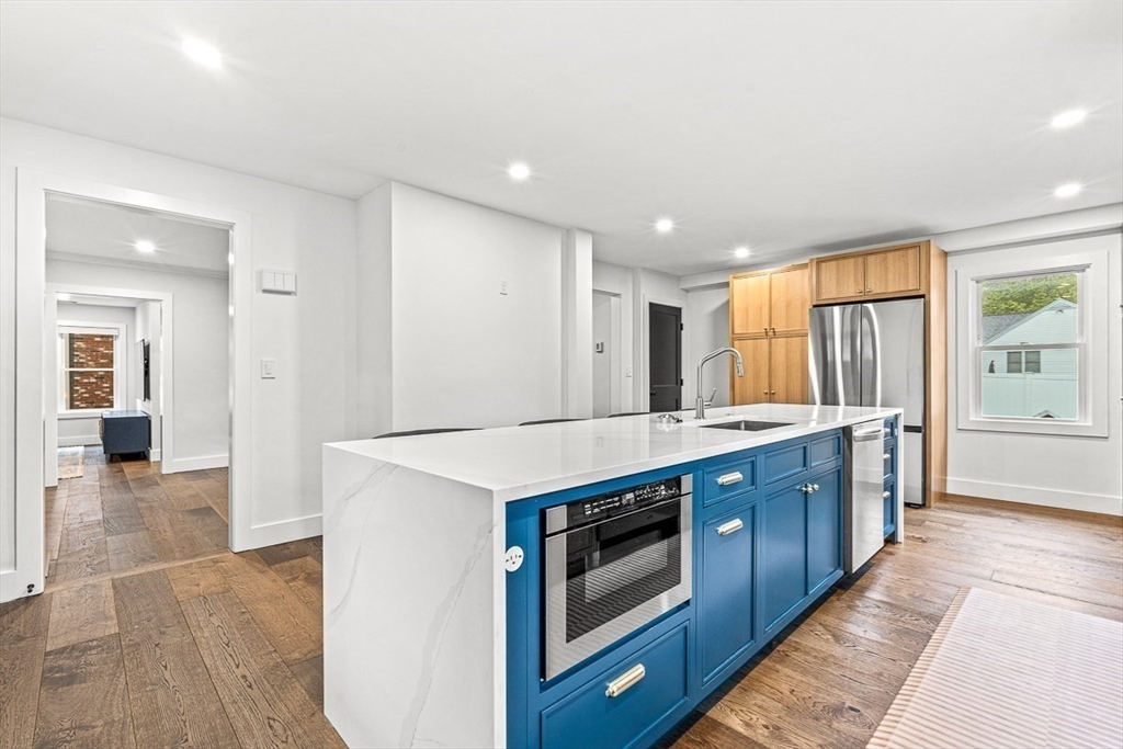 15 Rustic Road Stoneham, MA 02180 - Photo 11 of 42 a kitchen with stainless steel appliances granite countertop a stove and a sink
