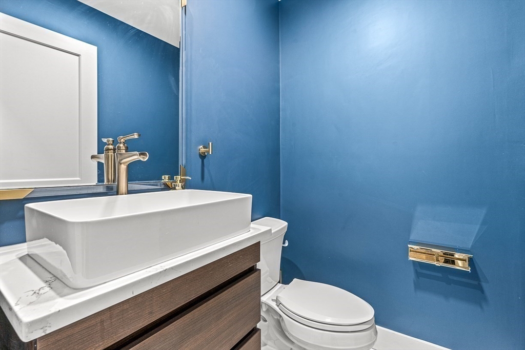 15 Rustic Road Stoneham, MA 02180 - Photo 17 of 42 a bathroom with a sink a toilet and mirror