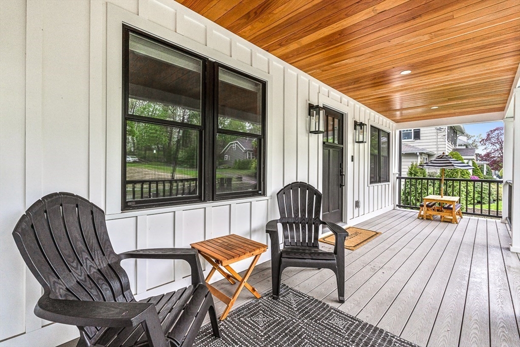 15 Rustic Road Stoneham, MA 02180 - Photo 2 of 42 a view of a patio with table and chairs and wooden floor