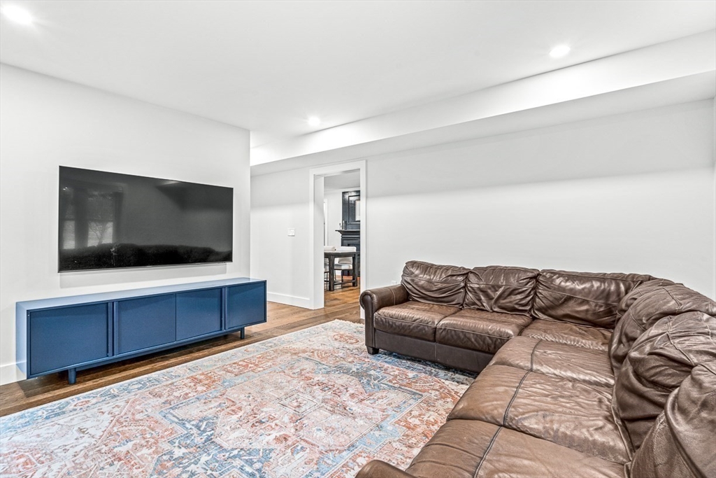 15 Rustic Road Stoneham, MA 02180 - Photo 21 of 42 a living room with a couch and a flat screen tv