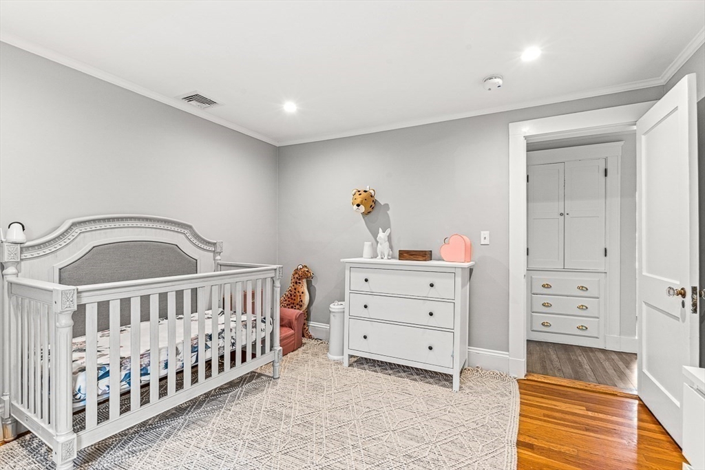 15 Rustic Road Stoneham, MA 02180 - Photo 23 of 42 a bedroom with furniture and baby crib