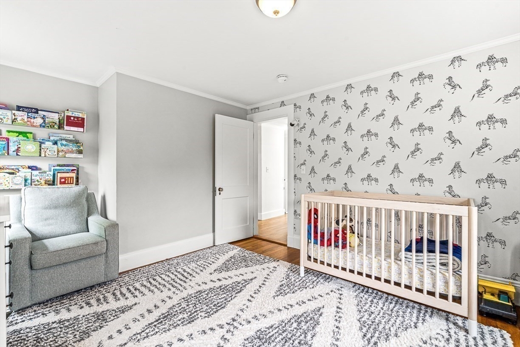 15 Rustic Road Stoneham, MA 02180 - Photo 30 of 42 a bedroom with furniture and baby crib
