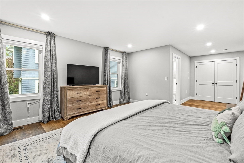 15 Rustic Road Stoneham, MA 02180 - Photo 35 of 42 a bedroom with a bed and a flat screen tv