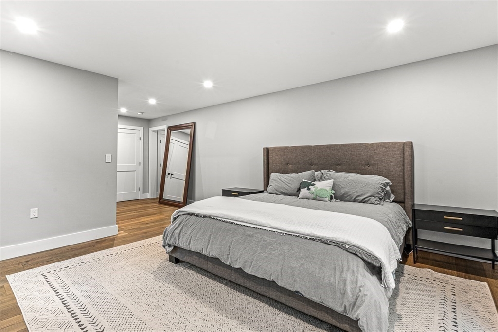 15 Rustic Road Stoneham, MA 02180 - Photo 36 of 42 a spacious bedroom with a bed and a rug