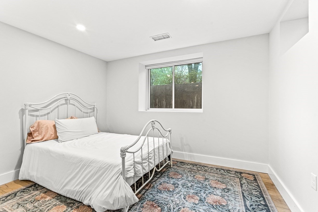 15 Rustic Road Stoneham, MA 02180 - Photo 38 of 42 a bedroom with a bed and a window