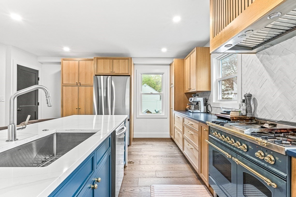 15 Rustic Road Stoneham, MA 02180 - Photo 5 of 42 a kitchen with stainless steel appliances granite countertop a sink stove and refrigerator