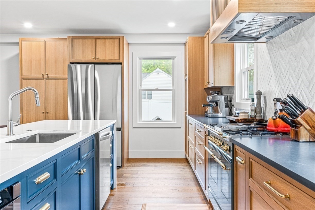 15 Rustic Road Stoneham, MA 02180 - Photo 6 of 42 a kitchen with stainless steel appliances granite countertop a sink stove and cabinets