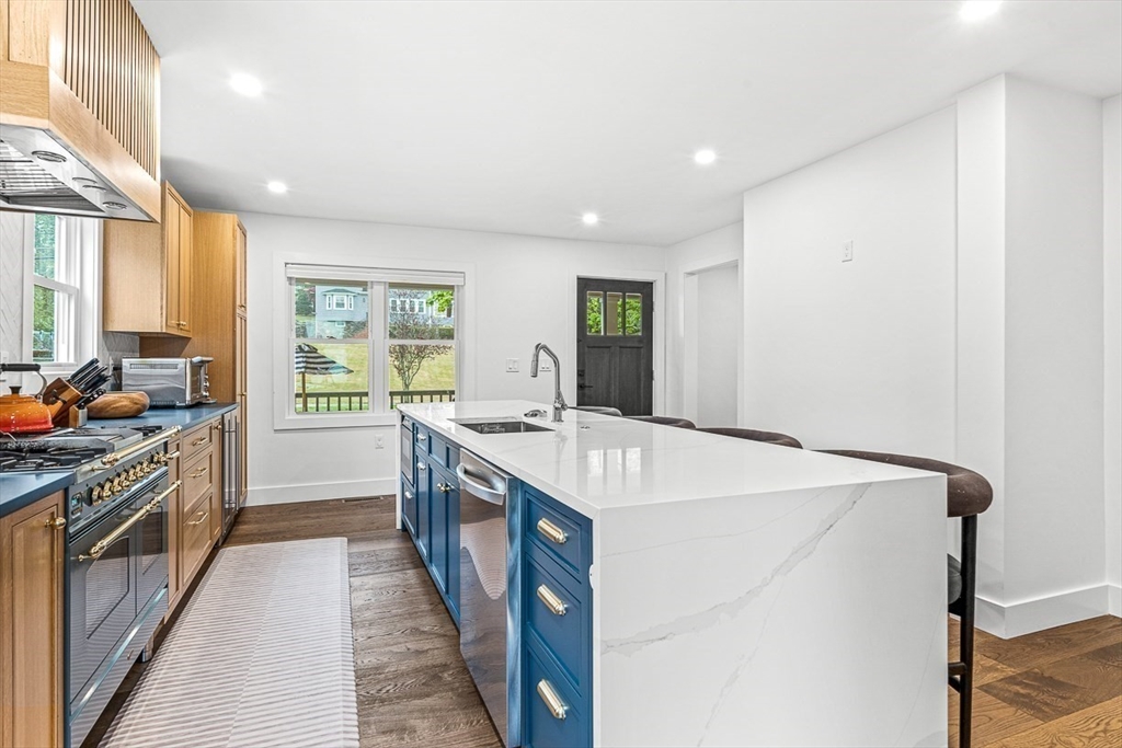 15 Rustic Road Stoneham, MA 02180 - Photo 8 of 42 a kitchen with a stove a sink and a refrigerator