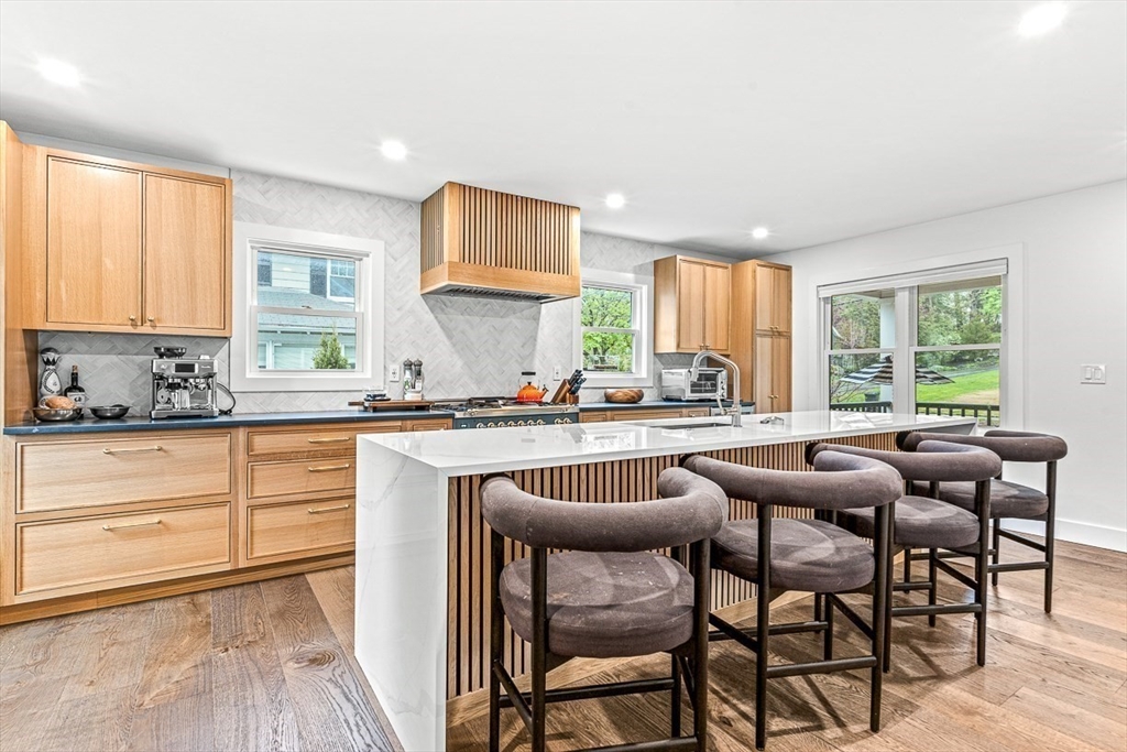 15 Rustic Road Stoneham, MA 02180 - Photo 9 of 42 a kitchen with stainless steel appliances granite countertop table chairs sink and cabinets