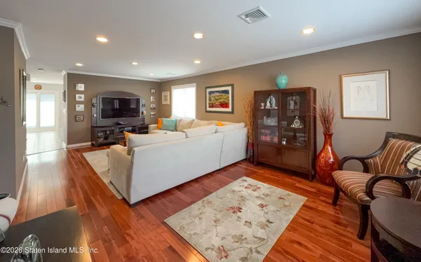 a kitchen with stainless steel appliances kitchen island granite countertop a dining table chairs and white cabinets