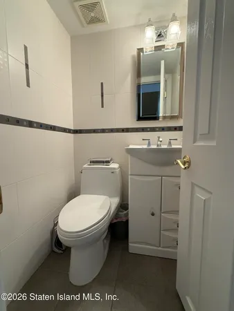 a spacious bathroom with a granite countertop sink a mirror and shower