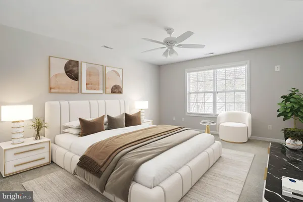 a bedroom with furniture and a flat screen tv