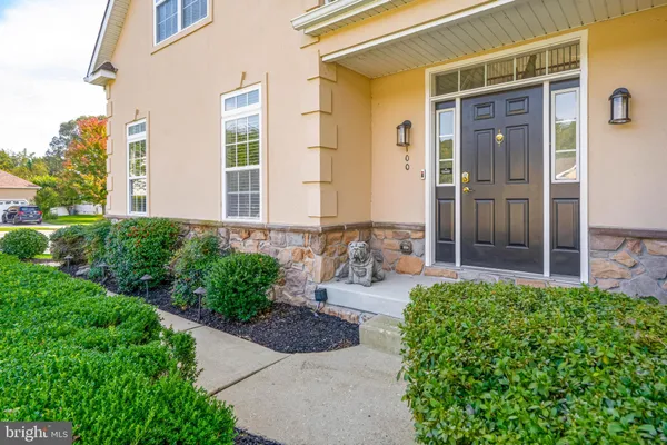 a front view of a house with a yard outdoor seating and plants
