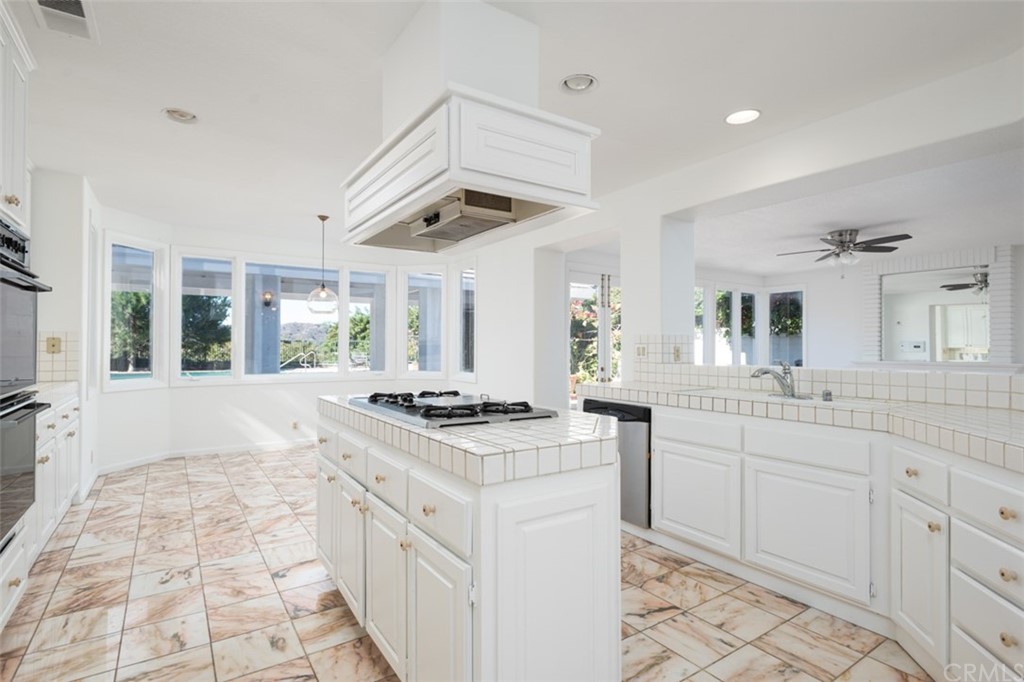 23 Summerside Coto de Caza, CA 92679 - Photo 11 of 34 a kitchen with a stove sink and cabinets