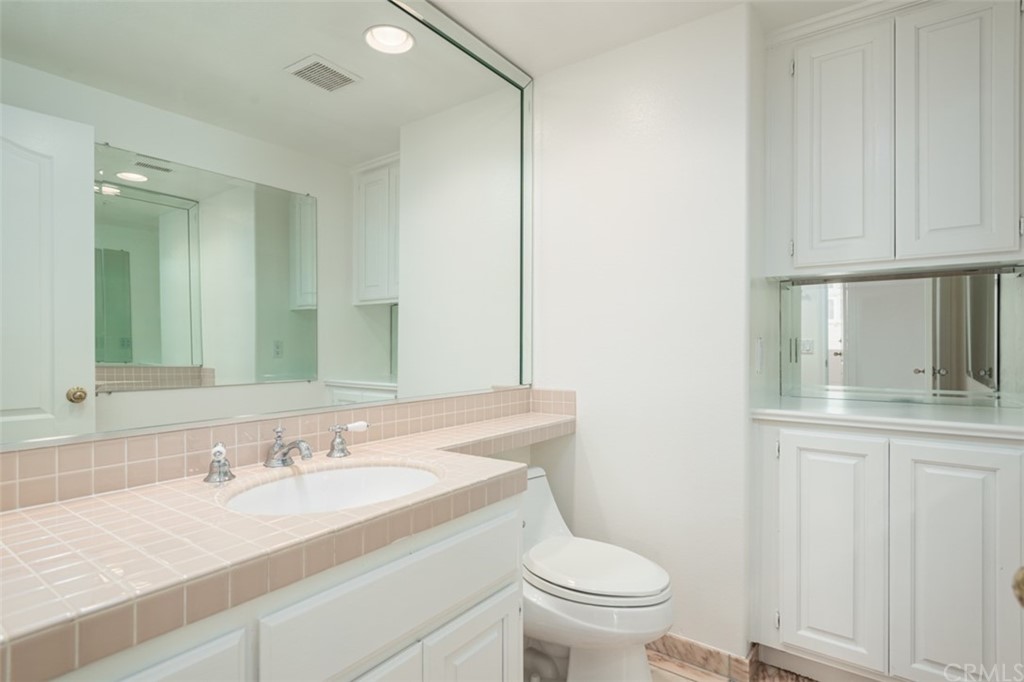 23 Summerside Coto de Caza, CA 92679 - Photo 14 of 34 a hallway with white cabinets and window