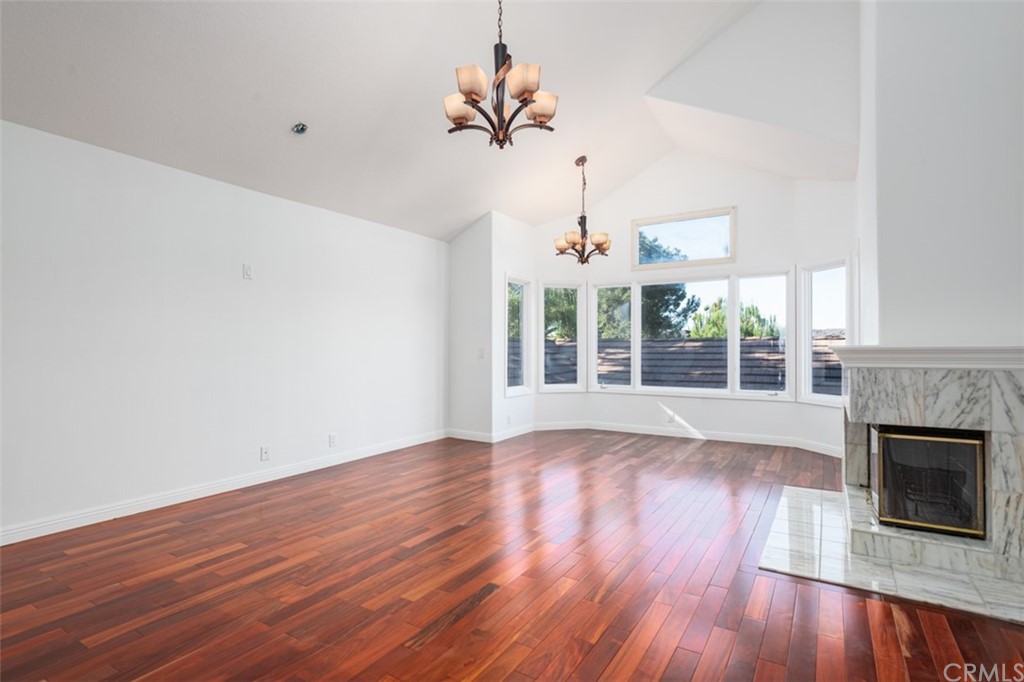 23 Summerside Coto de Caza, CA 92679 - Photo 16 of 34 an empty room with wooden floor fireplace and windows