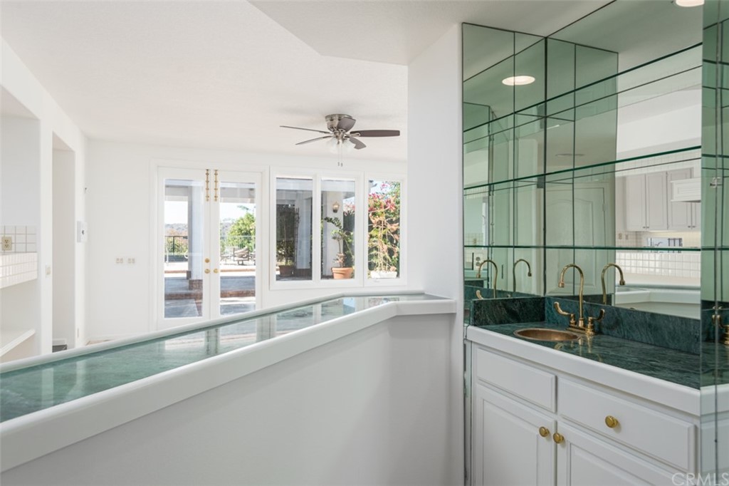 23 Summerside Coto de Caza, CA 92679 - Photo 8 of 34 a view of a bathroom with a sink and mirror next to a window