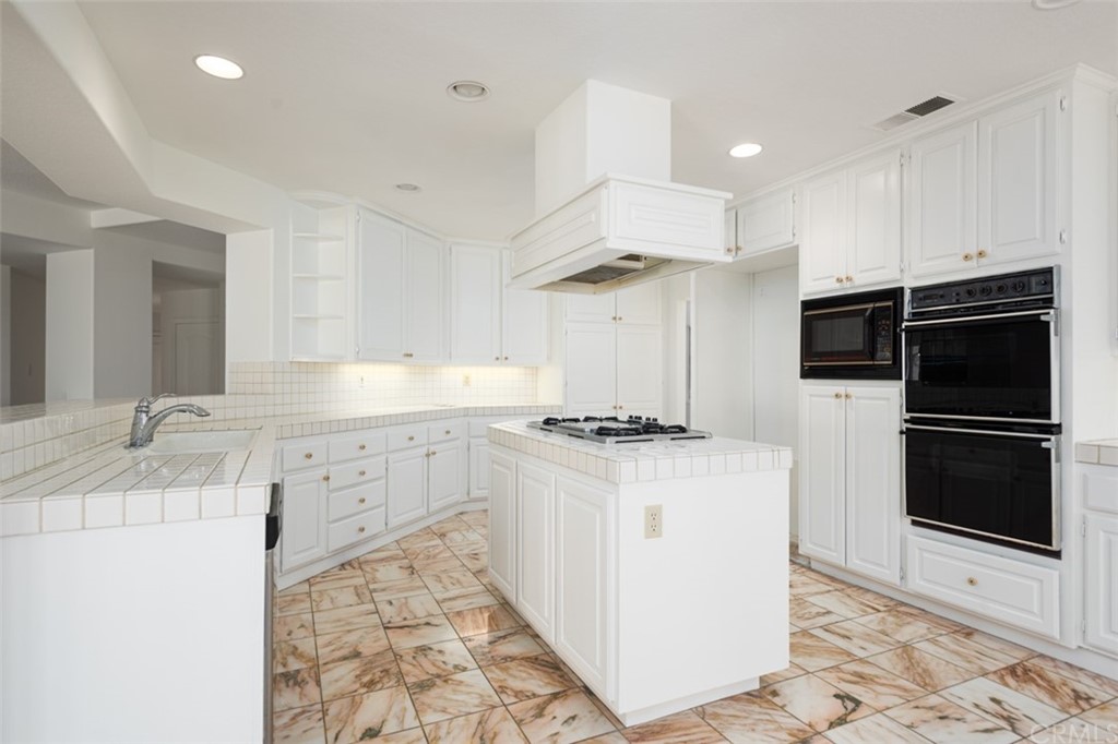 23 Summerside Coto de Caza, CA 92679 - Photo 9 of 34 a kitchen with stainless steel appliances a stove a sink and a refrigerator