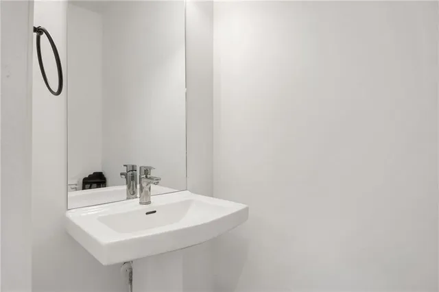 a bathroom with a sink and mirror