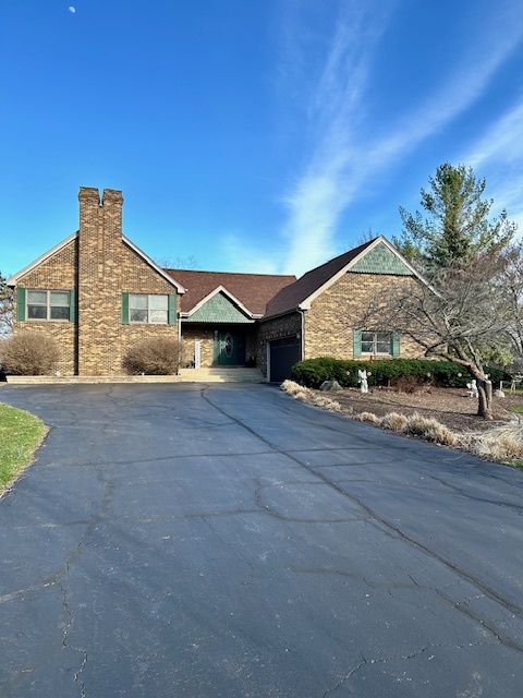 6414 Suttondale Road Huntley, IL 60142 - Photo 1 of 24 a front view of a house with a yard and garage