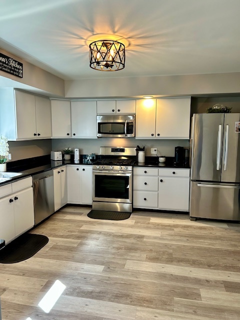 6414 Suttondale Road Huntley, IL 60142 - Photo 3 of 24 a kitchen with granite countertop a refrigerator a stove top oven a sink and dishwasher